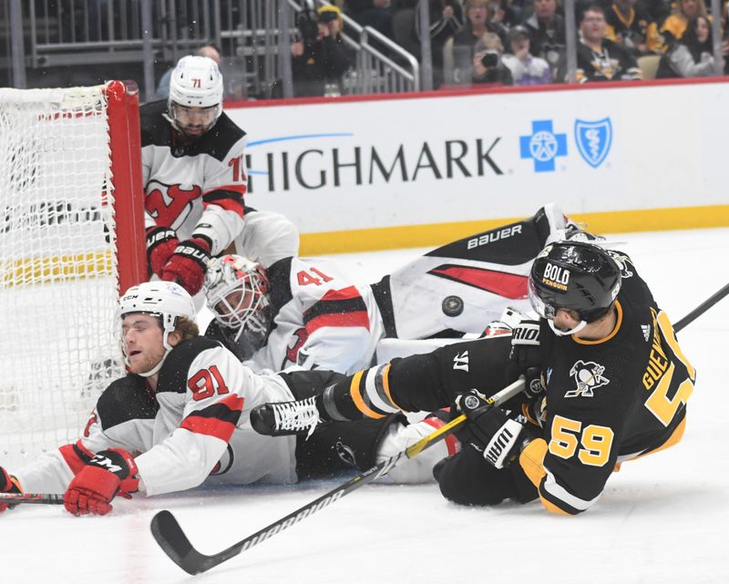 Nov 16, 2023; Pittsburgh, Pennsylvania, USA; Pittsburgh Penguins left wing Jake Guentzel (58) crashes into New Jersey Devils goalie Vitek Vanecek (41) and center Dawson Mercer (91) during the first period at PPG Paints Arena. Mandatory Credit: Philip G. Pavely-USA TODAY Sports