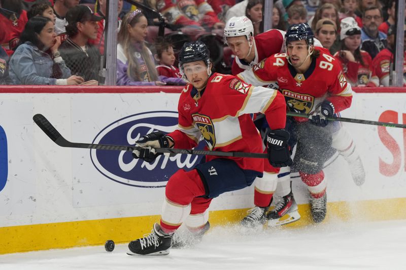 Dec 30, 2023; Sunrise, Florida, USA; Florida Panthers defenseman Brandon Montour (62) looks to clear the puck as left wing Ryan Lomberg (94) and Montreal Canadiens right wing Jesse Ylonen (56) follow on the play during the first period at Amerant Bank Arena. Mandatory Credit: Jim Rassol-USA TODAY Sports