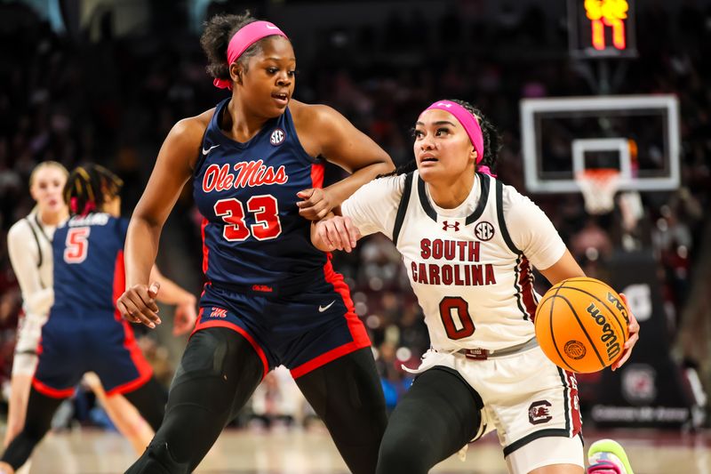 Feb 4, 2024; Columbia, South Carolina, USA; South Carolina Gamecocks guard Te-Hina Paopao (0) drives around Ole Miss Rebels forward Kharyssa Richardson (33) in the first half at Colonial Life Arena. Mandatory Credit: Jeff Blake-USA TODAY Sports