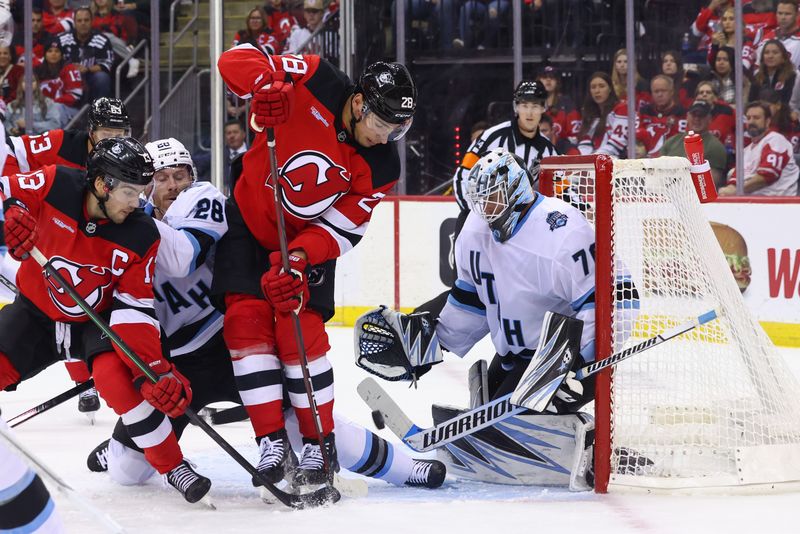 Oct 14, 2024; Newark, New Jersey, USA; Utah Hockey Club goaltender Karel Vejmelka (70) makes a save while New Jersey Devils right wing Timo Meier (28) looks for the rebound during the second period at Prudential Center. Mandatory Credit: Ed Mulholland-Imagn Images