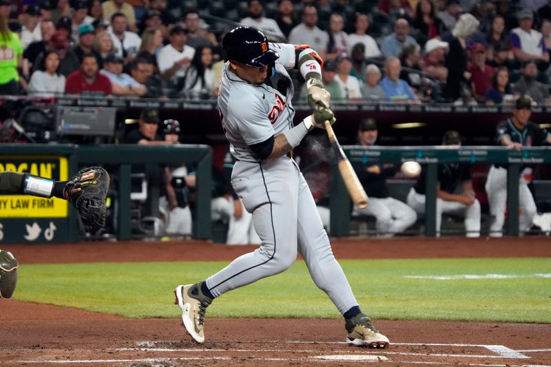 May 17, 2024; Phoenix, Arizona, USA; Detroit Tigers shortstop Javier Báez (28) hits an RBI single against the Arizona Diamondbacks in the second inning at Chase Field. Mandatory Credit: Rick Scuteri-USA TODAY Sports