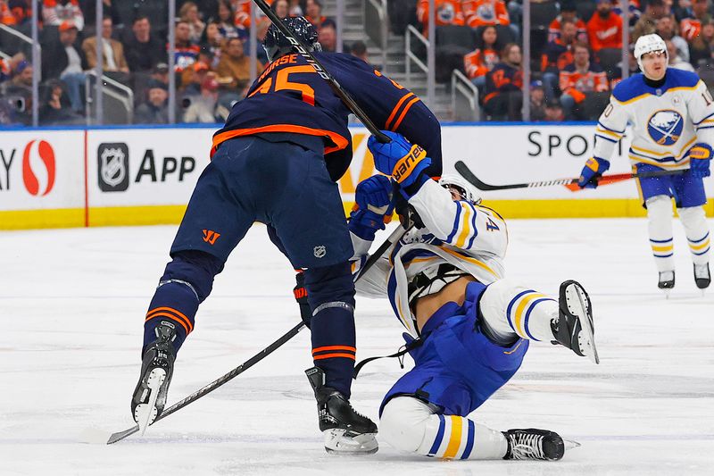 Mar 21, 2024; Edmonton, Alberta, CAN; Edmonton Oilers defensemen Darnell Nurse (25) checks Buffalo Sabres forward Dylan Cozens (24) during the second period at Rogers Place. Mandatory Credit: Perry Nelson-USA TODAY Sports