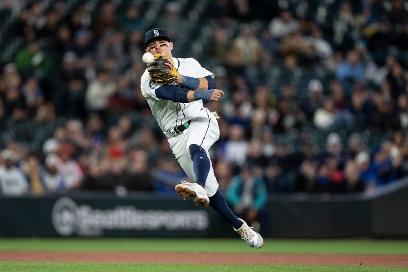 Apr 29, 2024; Seattle, Washington, USA; Seattle Mariners third baseman Luis Urias (16) throws to first base for an out after fielding a ground ball during the third inning against the Atlanta Braves at T-Mobile Park. Mandatory Credit: Stephen Brashear-USA TODAY Sports