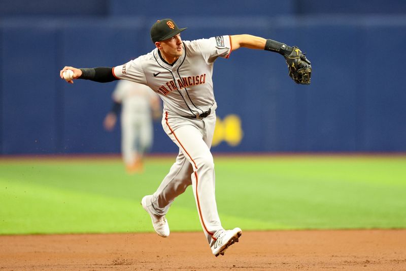 Apr 13, 2024; St. Petersburg, Florida, USA;  San Francisco Giants shortstop Nick Ahmed (16) throws to first for an out against the Tampa Bay Rays in the second inning at Tropicana Field. Mandatory Credit: Nathan Ray Seebeck-USA TODAY Sports