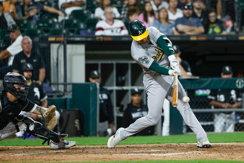 Aug 26, 2023; Chicago, Illinois, USA; Oakland Athletics left fielder Brent Rooker (25) singles against the Chicago White Sox during the eight inning at Guaranteed Rate Field. Mandatory Credit: Kamil Krzaczynski-USA TODAY Sports