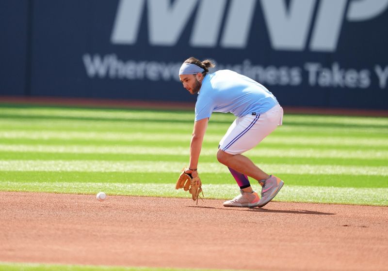 Jun 29, 2023; Toronto, Ontario, CAN; Toronto Blue Jays shortstop Bo Bichette (11) fields balls during batting practice against the San Francisco Giants at Rogers Centre. Mandatory Credit: Nick Turchiaro-USA TODAY Sports