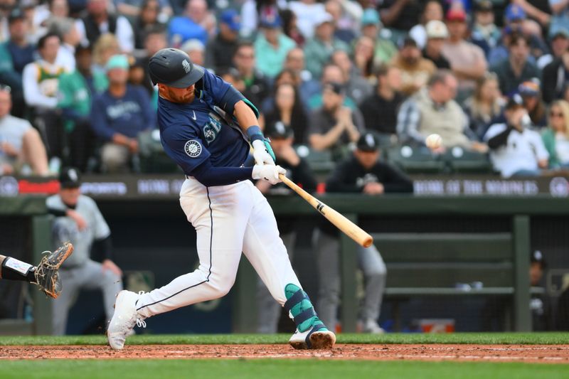 Jun 13, 2024; Seattle, Washington, USA; Seattle Mariners first baseman Tyler Locklear (27) hits a home run against the Chicago White Sox during the fifth inning at T-Mobile Park. Mandatory Credit: Steven Bisig-USA TODAY Sports