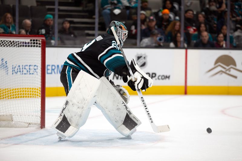 Oct 31, 2024; San Jose, California, USA; San Jose Sharks goaltender Mackenzie Blackwood (29) deflects another Chicago Blackhawks shot on goal during the first period at SAP Center at San Jose. Mandatory Credit: D. Ross Cameron-Imagn Images