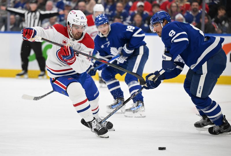 Apr 12, 2025; Toronto, Ontario, CAN;  Toronto Maple Leafs defenseman Chris Tanev (8) breaks up a rush by Montreal Canadiens forward Alex Newhook (15) in the second period at Scotiabank Arena. Mandatory Credit: Dan Hamilton-Imagn Images
