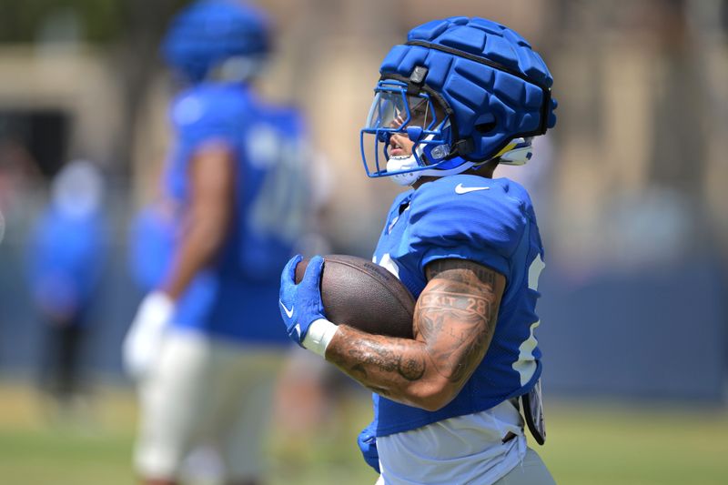 Los Angeles Rams running back Blake Corum carries the ball during a joint practice with the Dallas Cowboys at the Cowboy's NFL football training camp Thursday, Aug. 8, 2024, in Oxnard, Calif. (AP Photo/Jayne Kamin-Oncea)