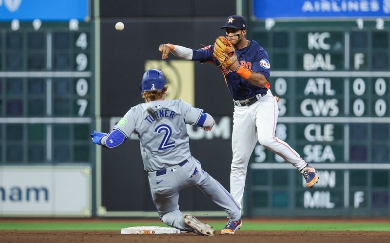 Apr 2, 2024; Houston, Texas, USA; Toronto Blue Jays designated hitter Justin Turner (2) is out as Houston Astros shortstop Jeremy Pena (3) throws to first base to complete a double play during the seventh inning at Minute Maid Park. Mandatory Credit: Troy Taormina-USA TODAY Sports