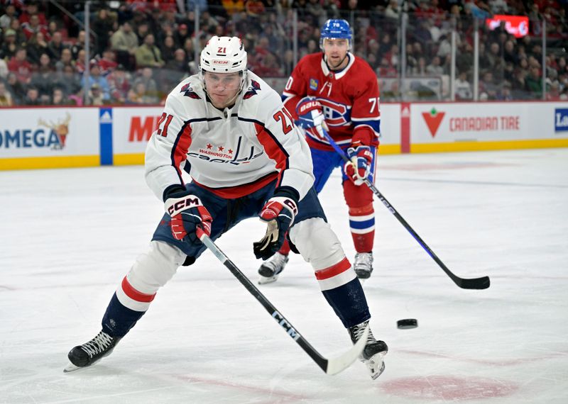 Feb 17, 2024; Montreal, Quebec, CAN; Washington Capitals forward Aliaksei Protas (21) plays the puck and Montreal Canadiens forward Tanner Pearson (70) defends during the third period at the Bell Centre. Mandatory Credit: Eric Bolte-USA TODAY Sports