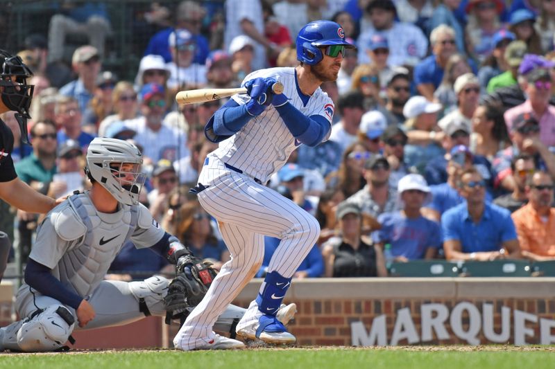 Aug 22, 2024; Chicago, Illinois, USA;  Chicago Cubs right fielder Cody Bellinger (24) hits an RBI single during the fourth inning against the Detroit Tigers at Wrigley Field. Mandatory Credit: Patrick Gorski-USA TODAY Sports