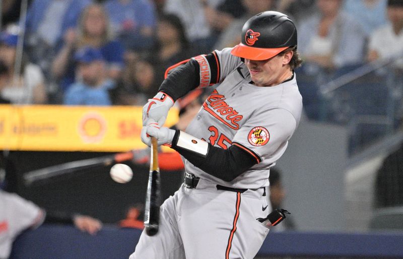 Jun 5, 2024; Toronto, Ontario, CAN;   Baltimore Orioles catcher Adley Rutschman (35) hits a single against the Toronto Blue Jays in the first inning at Rogers Centre. Mandatory Credit: Dan Hamilton-USA TODAY Sports 