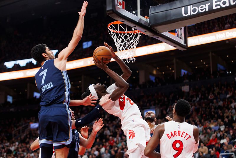 TORONTO, CANADA - JANUARY 22: Chris Boucher #25 of the Toronto Raptors goes up to the basket against Santi Aldama #7 of the Memphis Grizzlies in the first half at Scotiabank Arena on January 22, 2024 in Toronto, Canada. NOTE TO USER: User expressly acknowledges and agrees that, by downloading and or using this photograph, User is consenting to the terms and conditions of the Getty Images License Agreement. (Photo by Cole Burston/Getty Images)