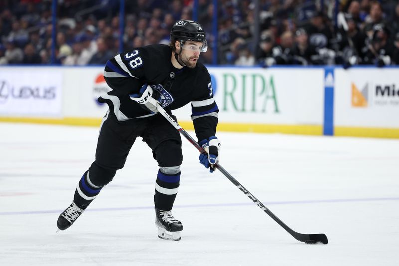 Feb 17, 2024; Tampa, Florida, USA;  Tampa Bay Lightning left wing Brandon Hagel (38) controls the puck against the Florida Panthers in the third period at Amalie Arena. Mandatory Credit: Nathan Ray Seebeck-USA TODAY Sports