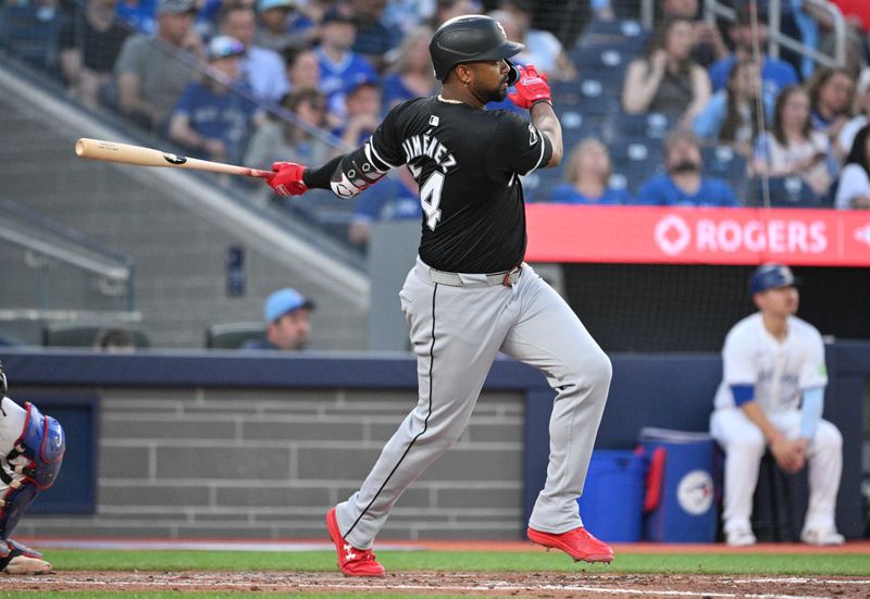 May 21, 2024; Toronto, Ontario, CAN;  Chicago White Sox designated hitter Eloy Jimenez (74) hits a double against the Toronto Blue Jays in the sixth inning at Rogers Centre. Mandatory Credit: Dan Hamilton-USA TODAY Sports