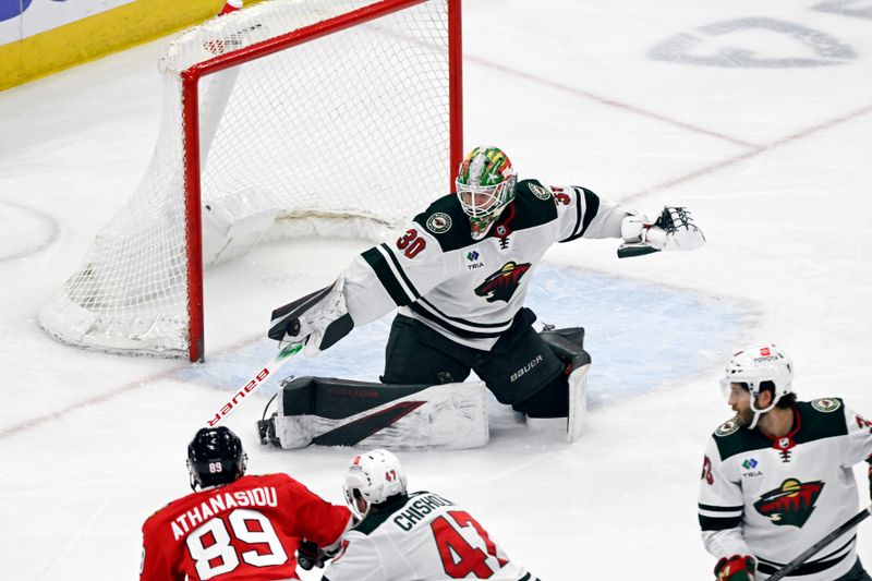 Apr 7, 2024; Chicago, Illinois, USA;  Minnesota Wild goaltender Jesper Wallstedt (30) defends against the Chicago Blackhawks during the first period at United Center. Mandatory Credit: Matt Marton-USA TODAY Sports