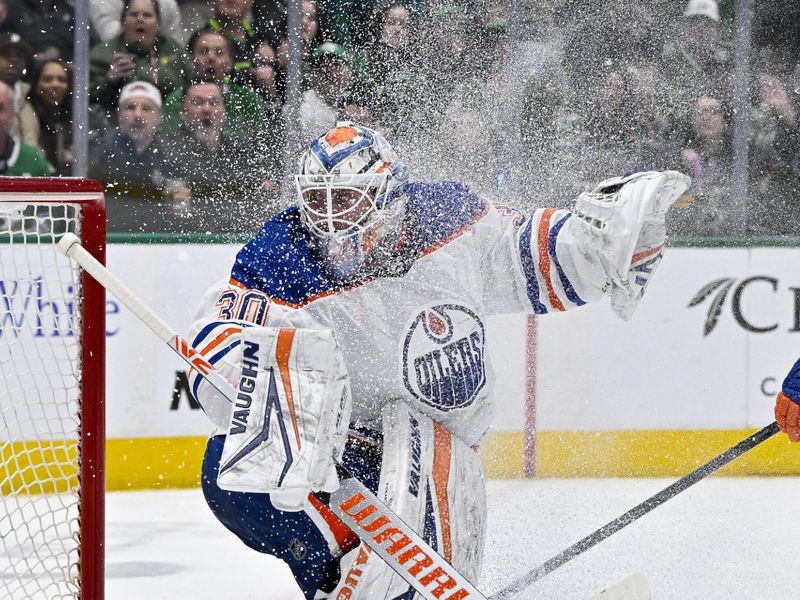 Apr 3, 2024; Dallas, Texas, USA; Edmonton Oilers goaltender Calvin Pickard (30) is sprayed with ice and snow after facing a Dallas Stars shot during the second period at the American Airlines Center. Mandatory Credit: Jerome Miron-USA TODAY Sports