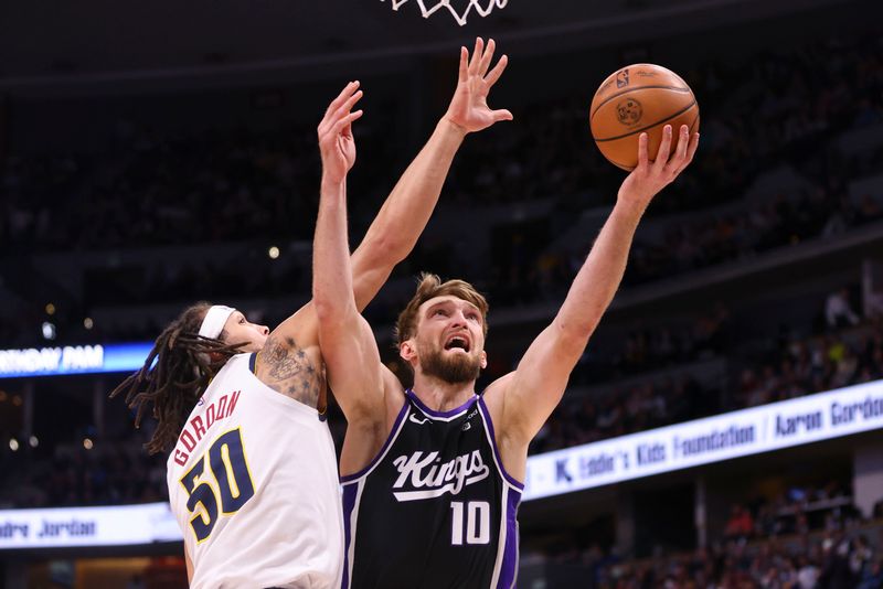 DENVER, COLORADO - FEBRUARY 28: Domantas Sabonis #10 of the Sacramento Kings attempts a layup while Aaron Gordon #50 of the Denver Nuggets defends during the game at Ball Arena on February 28, 2024 in Denver, Colorado. NOTE TO USER: User expressly acknowledges and agrees that, by downloading and or using this photograph, User is consenting to the terms and conditions of the Getty Images License Agreement. (Photo by Alysa Rubin/Clarkson Creative/Getty Images)