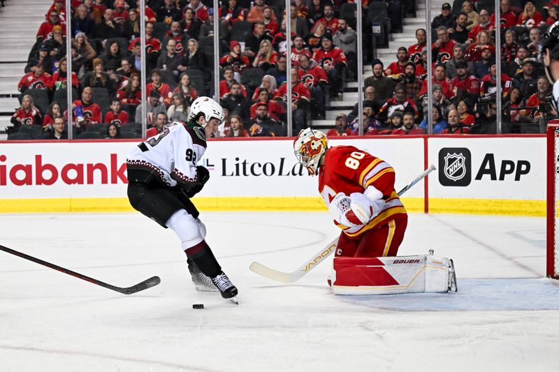 Jan 16, 2024; Calgary, Alberta, CAN; Calgary Flames goaltender Daniel Vladar (80) stops Arizona Coyotes center Logan Cooley (92) on a breakaway during the second period at Scotiabank Saddledome. Mandatory Credit: Brett Holmes-USA TODAY Sports