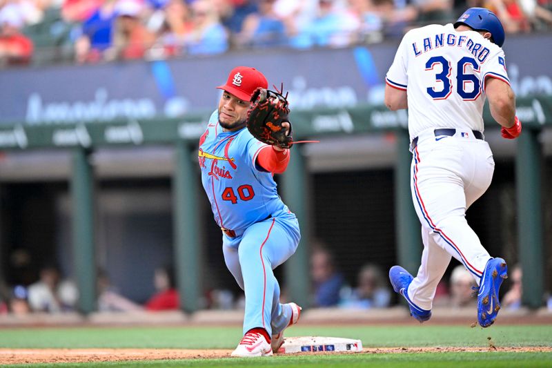 May 31, 2025; Arlington, Texas, USA; St. Louis Cardinals first baseman Willson Contreras (40) catches a throw to first base and puts out Texas Rangers center fielder Wyatt Langford (36) during the ninth inning at Globe Life Field. Mandatory Credit: Jerome Miron-Imagn Images