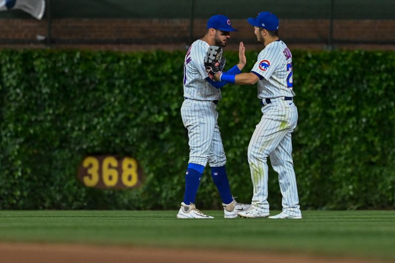 May 30, 2023; Chicago, Illinois, USA;  Chicago Cubs left fielder Mike Tauchman (40), left, and right fielder Seiya Suzuki (27) celebrate at the end of the game against the Tampa Bay Rays at Wrigley Field. Mandatory Credit: Matt Marton-USA TODAY Sports