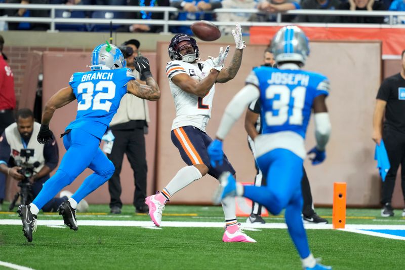 Chicago Bears wide receiver DJ Moore (2) catches a 31-yard touchdown reception as Detroit Lions safety Brian Branch (32) defends during the second half of an NFL football game in Detroit, Thursday, Nov. 28, 2024. (AP Photo/Carlos Osorio)