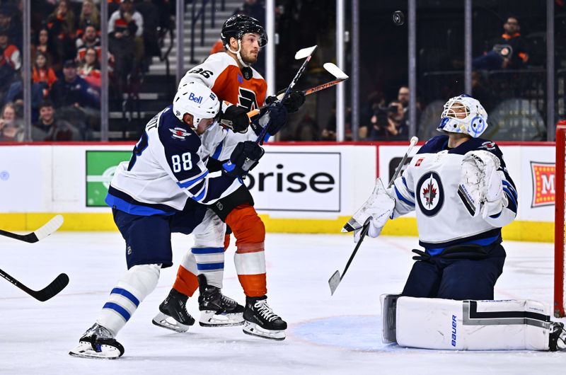 Feb 8, 2024; Philadelphia, Pennsylvania, USA; Philadelphia Flyers left wing Joel Farabee (86) and Winnipeg Jets defenseman Nate Schmidt (88) battle for a loose puck as goalie Laurent Brossoit (39) watches in the first period at Wells Fargo Center. Mandatory Credit: Kyle Ross-USA TODAY Sports