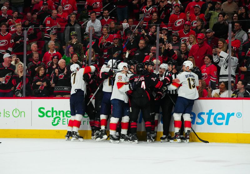 Mar 14, 2024; Raleigh, North Carolina, USA; Florida Panthers and Carolina Hurricanes players battle during the third period at PNC Arena. Mandatory Credit: James Guillory-USA TODAY Sports