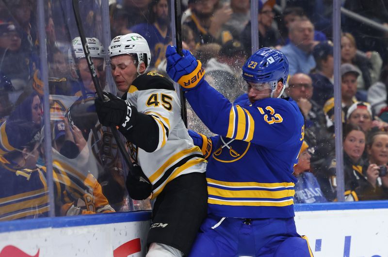 Apr 6, 2025; Buffalo, New York, USA;  Buffalo Sabres defenseman Mattias Samuelsson (23) checks Boston Bruins left wing Cole Koepke (45) during the first period at KeyBank Center. Mandatory Credit: Timothy T. Ludwig-Imagn Images