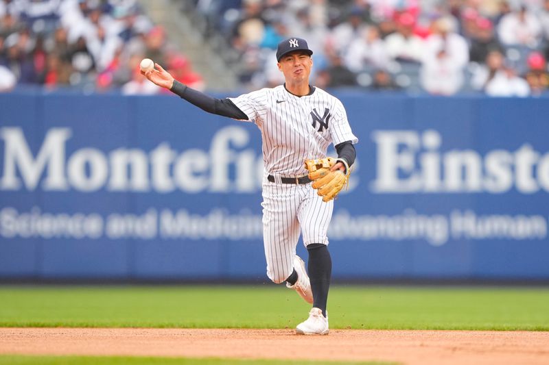 Apr 5, 2023; Bronx, New York, USA; New York Yankees shortstop Anthony Volpe (11) throws out Philadelphia Phillies catcher J.T. Realmuto (10) after fielding a ground ball during the fourth inning at Yankee Stadium. Mandatory Credit: Gregory Fisher-USA TODAY Sports