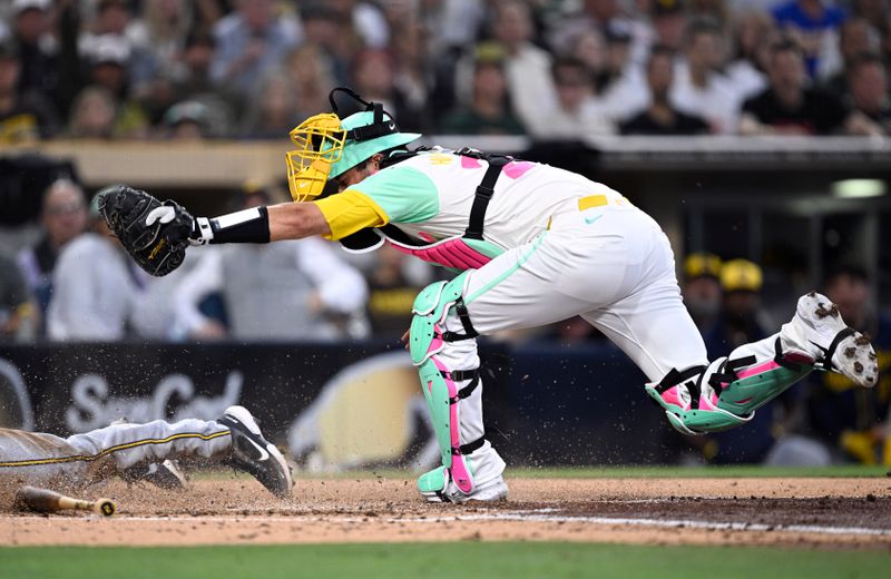 Jun 21, 2024; San Diego, California, USA; San Diego Padres catcher Kyle Higashioka (20) cannot tag out Milwaukee Brewers designated hitter Tyler Black (left) during the fifth inning at Petco Park. Mandatory Credit: Orlando Ramirez-USA TODAY Sports