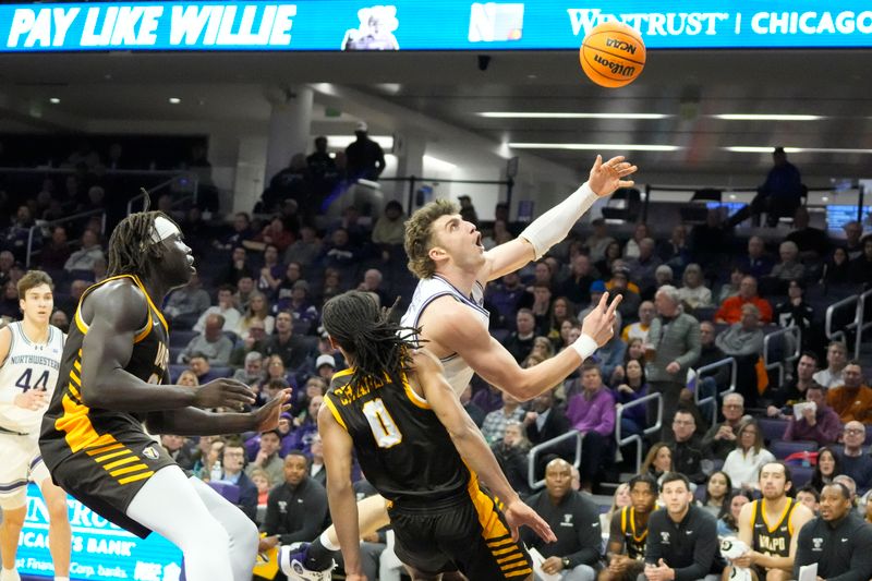 Dec 16, 2025; Evanston, Illinois, USA; Valparaiso Beacons guard Rakim Chaney (0) defends Northwestern Wildcats forward Nick Martinelli (2) during the first half at Welsh-Ryan Arena. Mandatory Credit: David Banks-Imagn Images