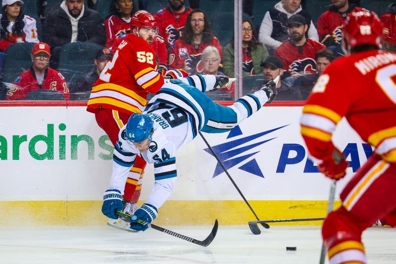 Apr 18, 2024; Calgary, Alberta, CAN; Calgary Flames defenseman MacKenzie Weegar (52) and San Jose Sharks center Mikael Granlund (64) collides during the first period at Scotiabank Saddledome. Mandatory Credit: Sergei Belski-USA TODAY Sports