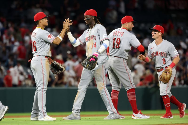 Aug 22, 2023; Anaheim, California, USA; Cincinnati Reds third baseman Noelvi Marte (16) and shortstop Elly De La Cruz (44) and first baseman Joey Votto (19) and second baseman Matt McLain (9) celebrate a victory after defeating the Los Angeles Angels 4-3 at Angel Stadium. Mandatory Credit: Kiyoshi Mio-USA TODAY Sports