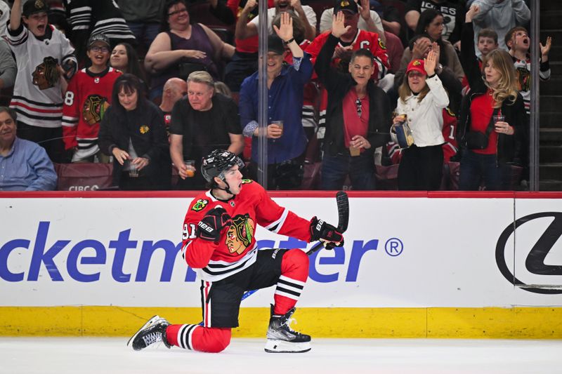 Apr 14, 2024; Chicago, Illinois, USA; Chicago Blackhawks forward Frank Nazar (91) celebrates after scoring his first NHL goal in his NHL debut in the first period against the Carolina Hurricanes at United Center. Mandatory Credit: Jamie Sabau-USA TODAY Sports