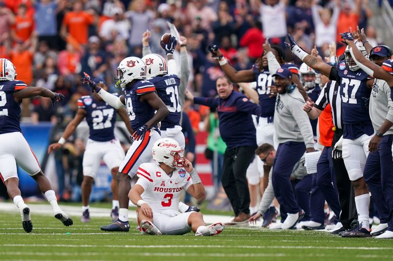 Dec 28, 2021; Birmingham, Alabama, USA; Auburn Tigers bench reacts after an interception against the Houston Cougars during the second half of the 2021 Birmingham Bowl at Protective Stadium. Mandatory Credit: Marvin Gentry-USA TODAY Sports