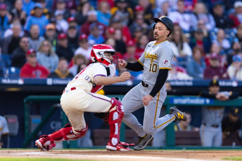 Apr 13, 2024; Philadelphia, Pennsylvania, USA; Pittsburgh Pirates outfielder Bryan Reynolds (10) scores in front of Philadelphia Phillies catcher Garrett Stubbs (21) during the first inning at Citizens Bank Park. Mandatory Credit: Bill Streicher-USA TODAY Sports