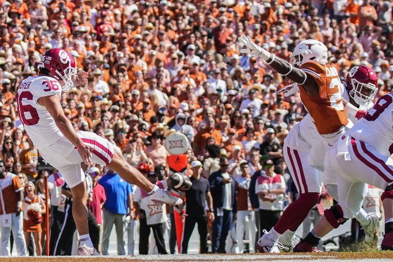 Oct 7, 2023; Dallas, Texas, USA; Texas Longhorns defensive back Kitan Crawford (21) blocks a punt by Oklahoma Sooners place kicker Josh Plaster (36) in the first quarter at the Cotton Bowl. This game makes up the 119th rivalry match up. Mandatory Credit: Ricardo B. Brazziell-USA TODAY Sports