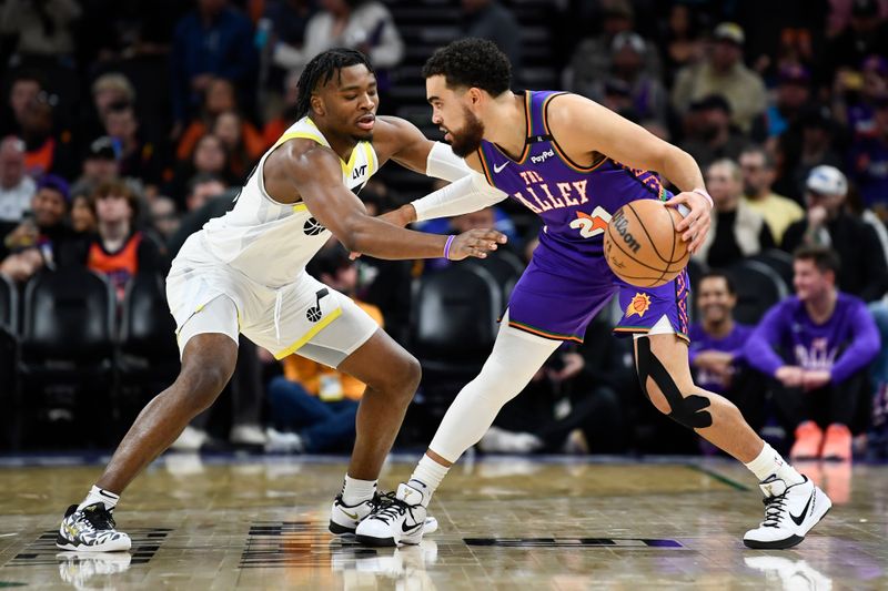 PHOENIX, ARIZONA - JANUARY 11: Tyus Jones #21 of the Phoenix Suns controls the ball against Isaiah Collier #13 of the Utah Jazz at Footprint Center on January 11, 2025 in Phoenix, Arizona. NOTE TO USER: User expressly acknowledges and agrees that, by downloading and or using this photograph, User is consenting to the terms and conditions of the Getty Images License Agreement. (Photo by Kelsey Grant/Getty Images)