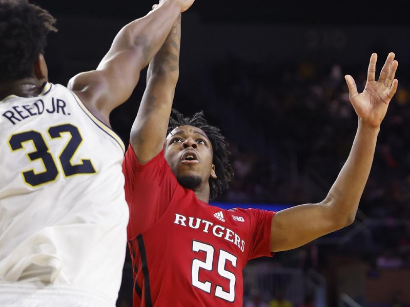 Feb 3, 2024; Ann Arbor, Michigan, USA;  Rutgers Scarlet Knights guard Jeremiah Williams (25) shoots on Michigan Wolverines forward Tarris Reed Jr. (32) in the second half at Crisler Center. Mandatory Credit: Rick Osentoski-USA TODAY Sports