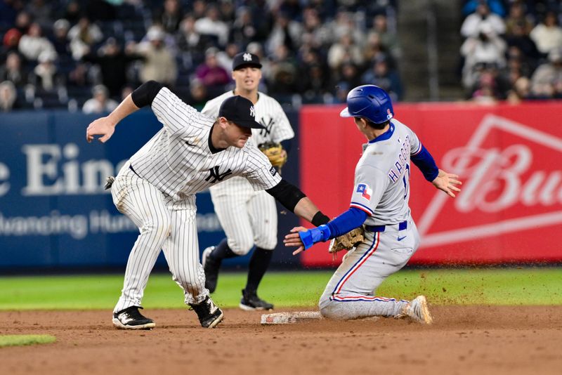 May 21, 2025; Bronx, New York, USA; New York Yankees second baseman DJ LeMahieu (26) tags out Texas Rangers outfielder Sam Haggerty (0) during a steal attempt at second base during the ninth inning at Yankee Stadium. Mandatory Credit: John Jones-Imagn Images