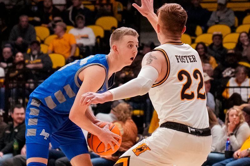 Feb 17, 2023; Laramie, Wyoming, USA; Air Force Falcons guard Jake Heidbreder (3) looks to pass against Wyoming Cowboys guard Kenny Foster (22) during the first half at Arena-Auditorium. Mandatory Credit: Troy Babbitt-USA TODAY Sports