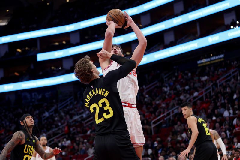 HOUSTON, TEXAS - JANUARY 20: Alperen Sengun #28 of the Houston Rockets shoots the ball while defended by Lauri Markkanen #23 of the Utah Jazz in the first half at Toyota Center on January 20, 2024 in Houston, Texas.  NOTE TO USER: User expressly acknowledges and agrees that, by downloading and or using this photograph, User is consenting to the terms and conditions of the Getty Images License Agreement. (Photo by Tim Warner/Getty Images)