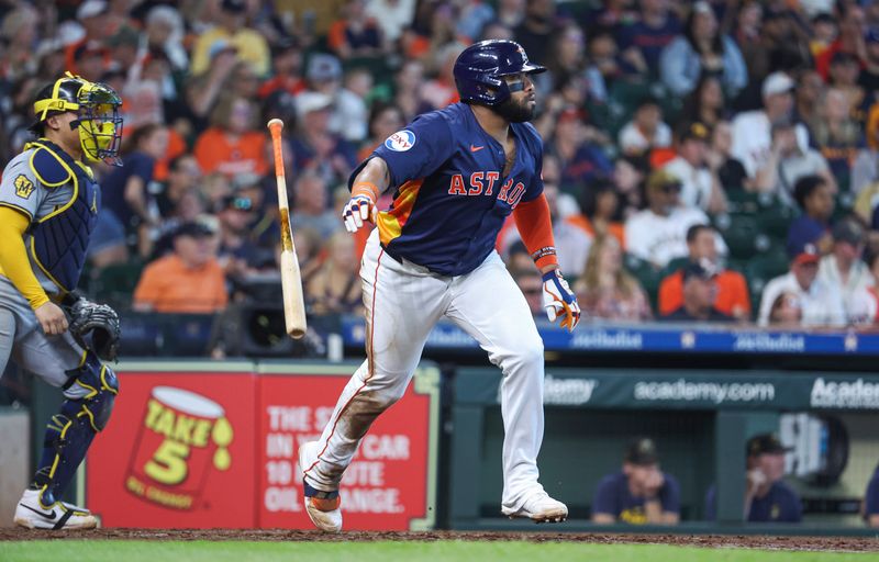 May 19, 2024; Houston, Texas, USA; Houston Astros first baseman Jon Singleton (28) hits an RBI single during the fifth inning against the Milwaukee Brewers at Minute Maid Park. Mandatory Credit: Troy Taormina-USA TODAY Sports