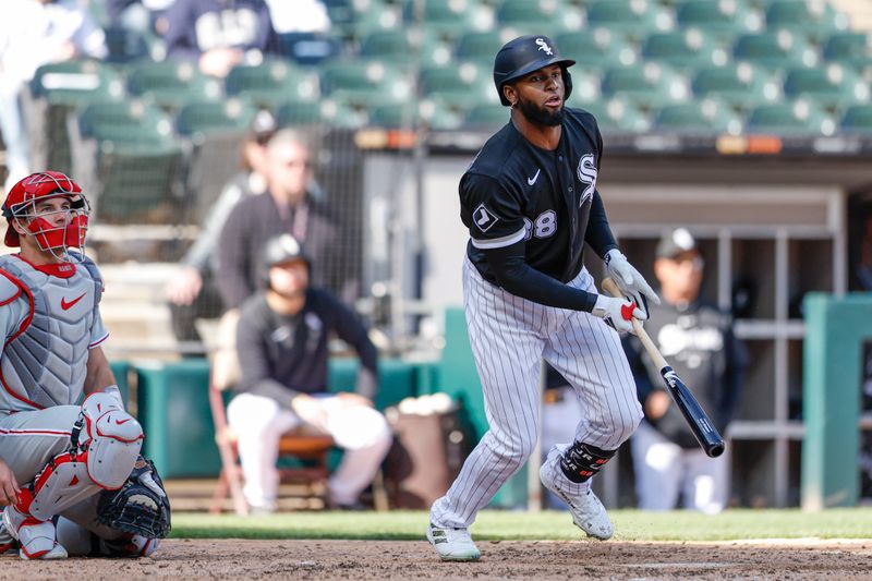 Apr 18, 2023; Chicago, Illinois, USA; Chicago White Sox center fielder Luis Robert Jr. (88) hits a two-run double against the Philadelphia Phillies during the third inning of game one of the doubleheader at Guaranteed Rate Field. Mandatory Credit: Kamil Krzaczynski-USA TODAY Sports