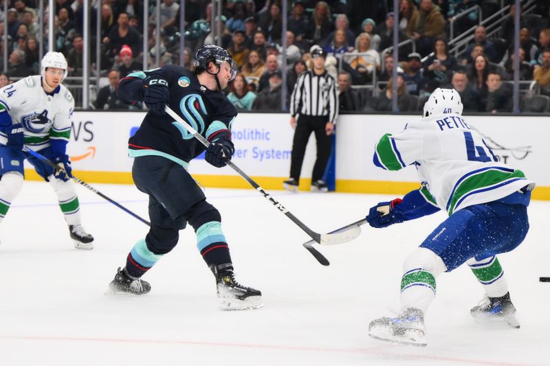 Feb 22, 2024; Seattle, Washington, USA; Seattle Kraken left wing Jared McCann (19) shoots a goal shot against the Vancouver Canucks during the second period at Climate Pledge Arena. Mandatory Credit: Steven Bisig-USA TODAY Sports