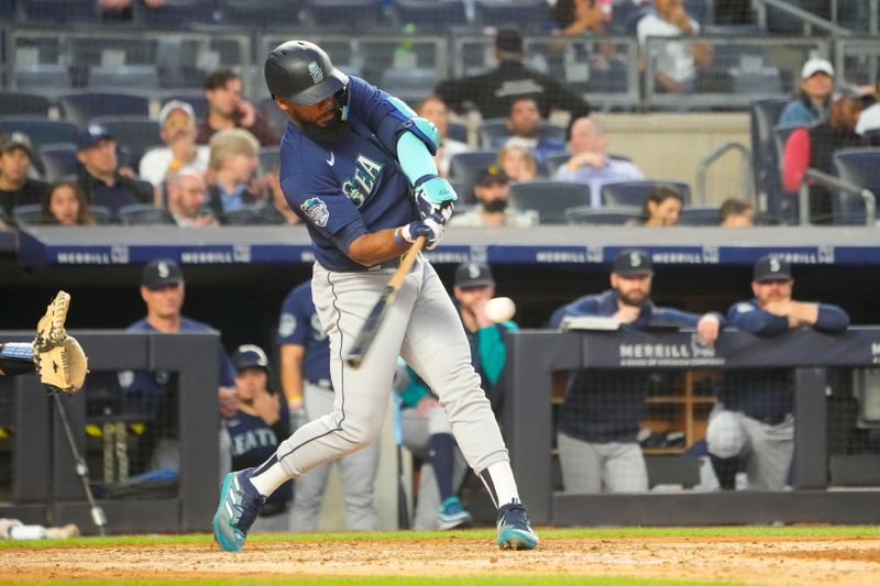 Jun 22, 2023; Bronx, New York, USA; Seattle Mariners right fielder Teoscar Hernandez (35) hits a home run against the New York Yankees during the fourth inning at Yankee Stadium. Mandatory Credit: Gregory Fisher-USA TODAY Sports