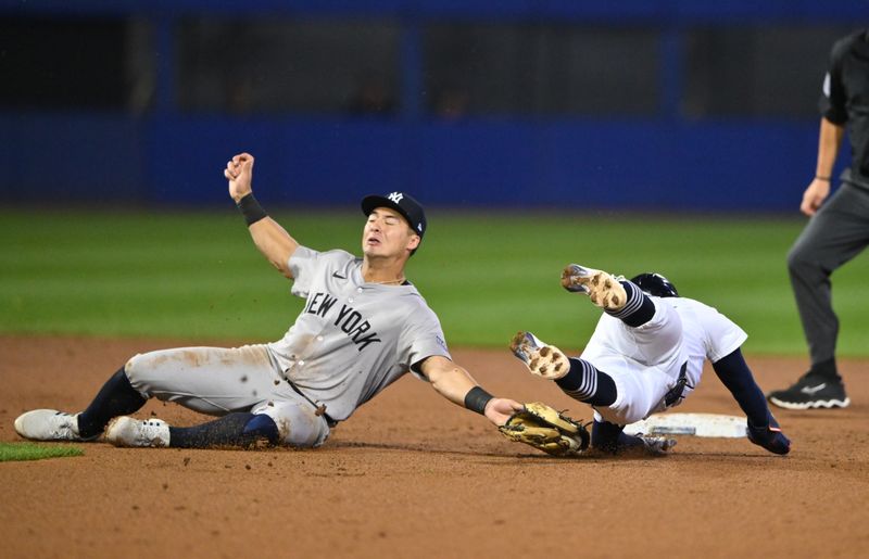 Aug 18, 2024; Williamsport, Pennsylvania, USA; Detroit Tigers infielder Zach McKinstry (39) dives past New York Yankees infielder Anthony Volpe (11) to steal second in the tenth inning at BB&T Ballpark at Historic Bowman Field. Mandatory Credit: Kyle Ross-USA TODAY Sports